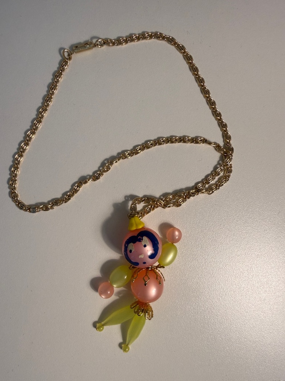 Vintage Gold-Tone Necklace with Pink, Peach and Lime Doll Pendant
